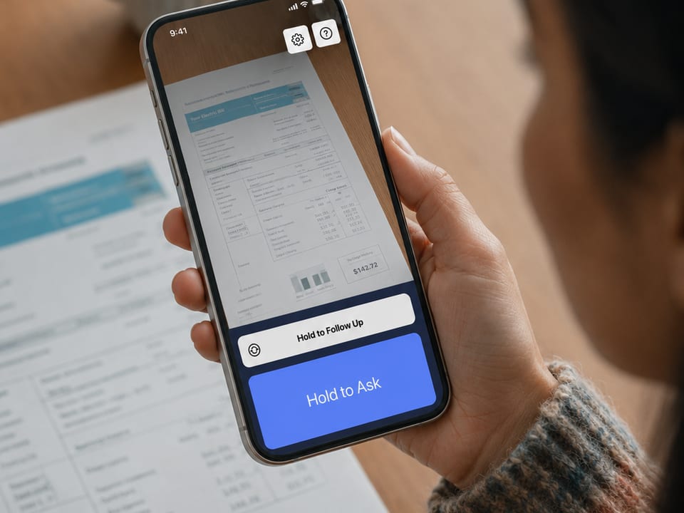 A person holds an iPhone running Speakaboo over a printed utility bill, the Hold to Ask button on screen.